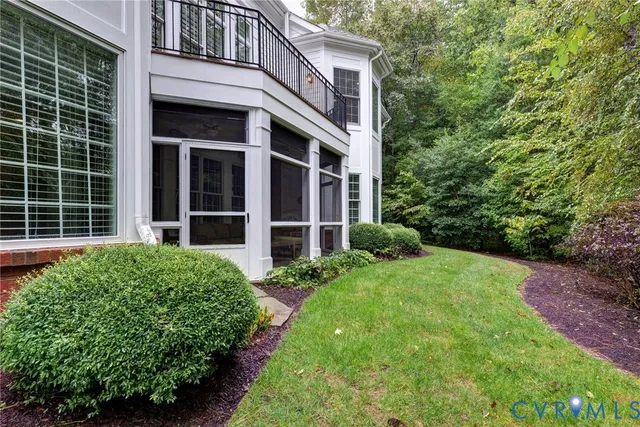 a front view of a house with a yard and potted plants