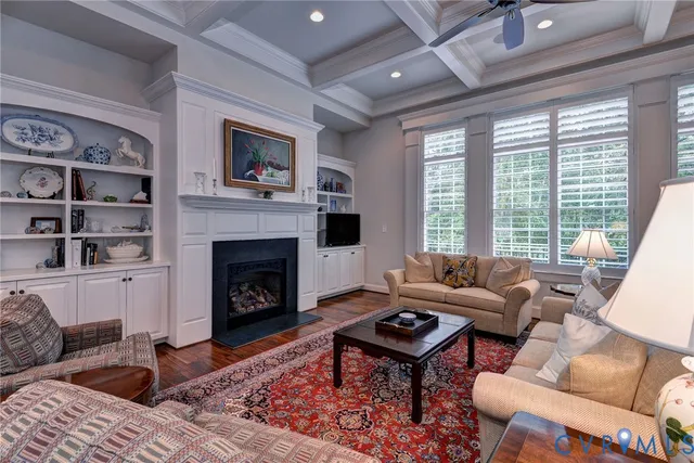 a living room with furniture a rug and a fireplace