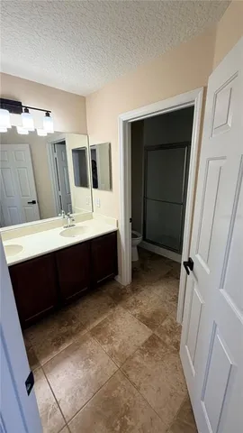 a bathroom with a double vanity sink and mirror