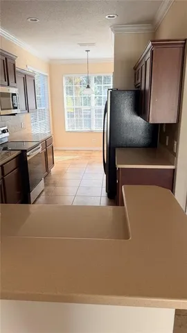 a kitchen with stainless steel appliances granite countertop a sink and a stove