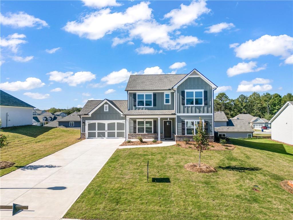 448 Banff Drive Winder, GA 30680 - Photo 1 of 16 a front view of a house with swimming pool having outdoor seating