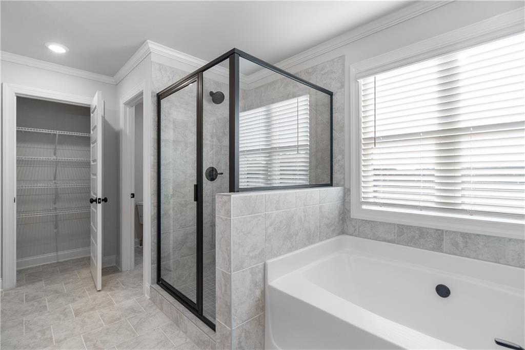 448 Banff Drive Winder, GA 30680 - Photo 13 of 16 a bathroom with a bathtub and a shower