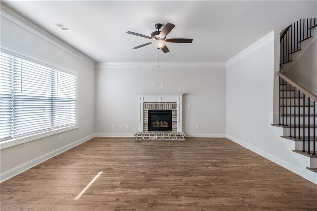 448 Banff Drive Winder, GA 30680 - Photo 4 of 16 a view of an empty room with a fireplace and a window