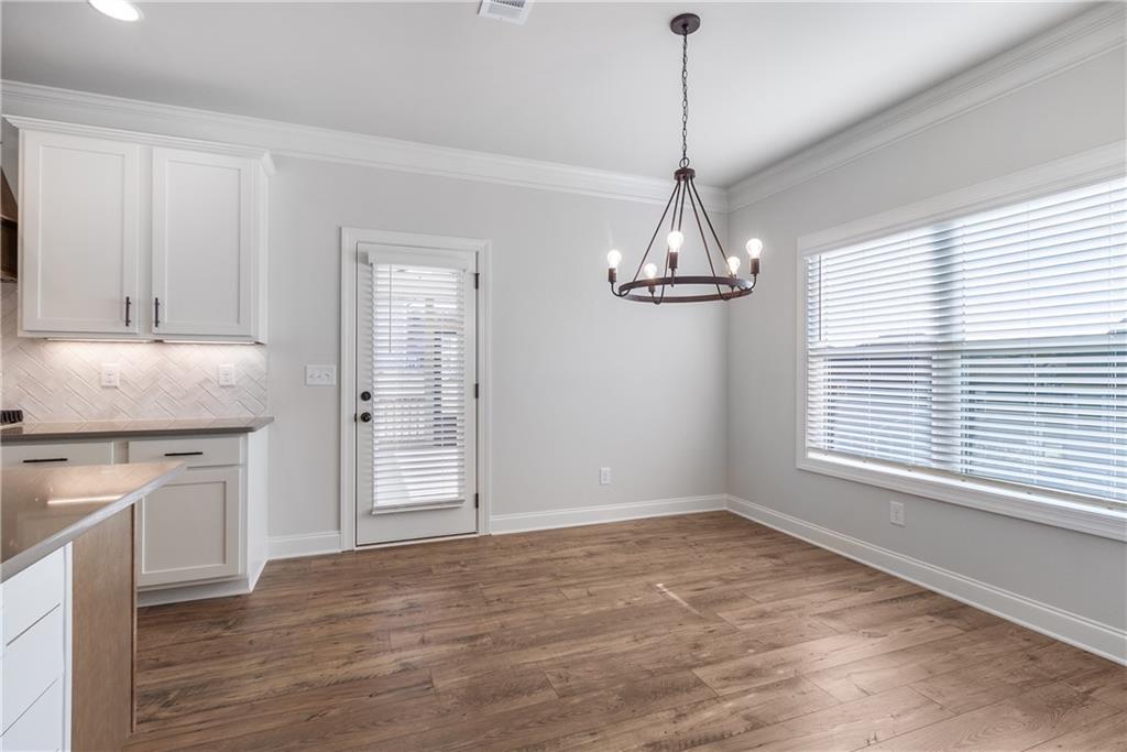 448 Banff Drive Winder, GA 30680 - Photo 5 of 16 a view of empty room with wooden floor and fan