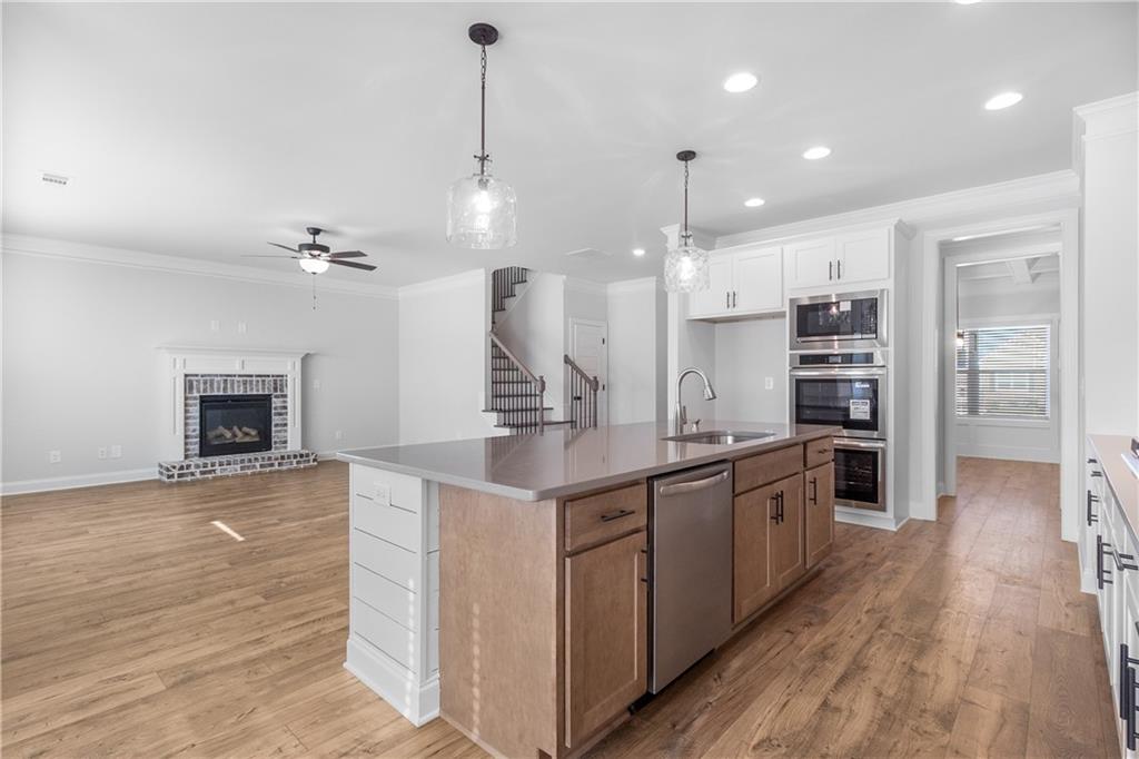 448 Banff Drive Winder, GA 30680 - Photo 7 of 16 a kitchen with kitchen island a counter top space appliances and cabinets