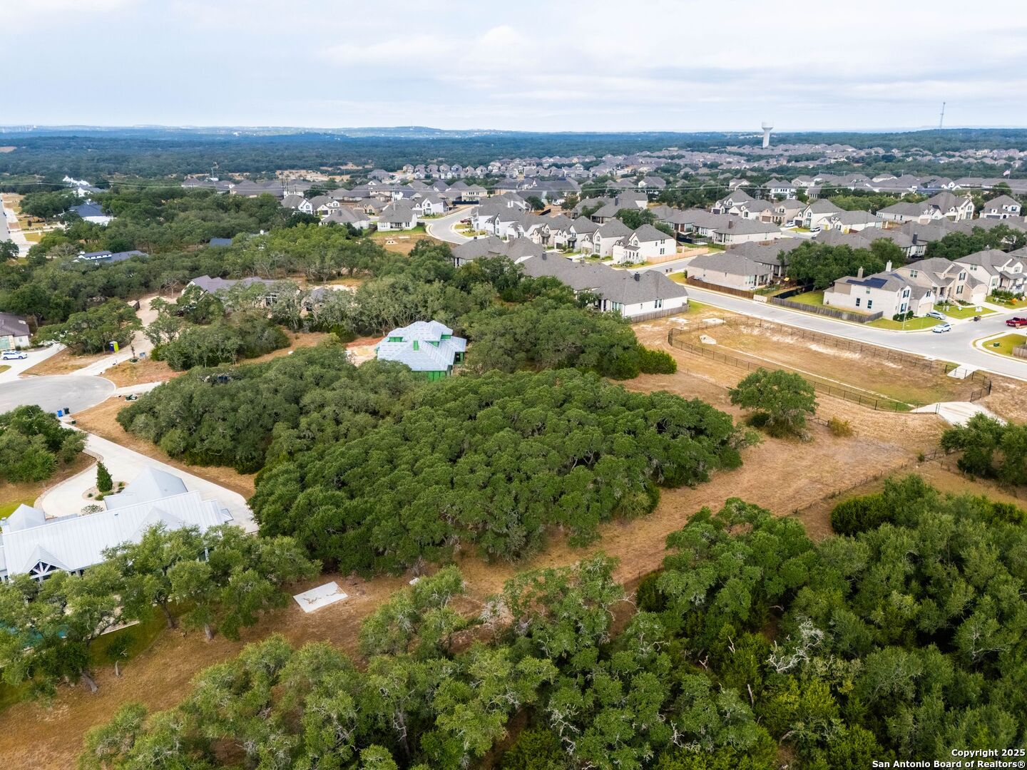 34858 Last Stage Way Bulverde, TX 78163 - Photo 16 of 16 an aerial view of a city with lots of residential buildings ocean and mountain view in back