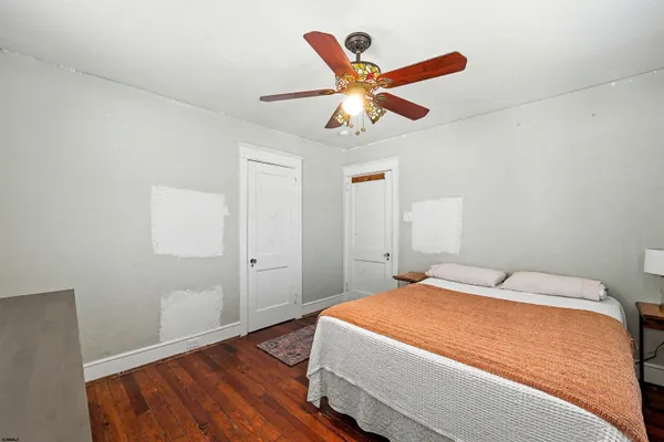 a bedroom with a large bed and a chandelier