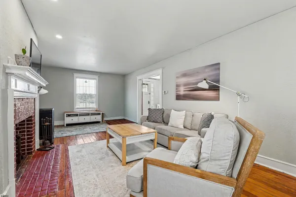 a living room with furniture and a fireplace