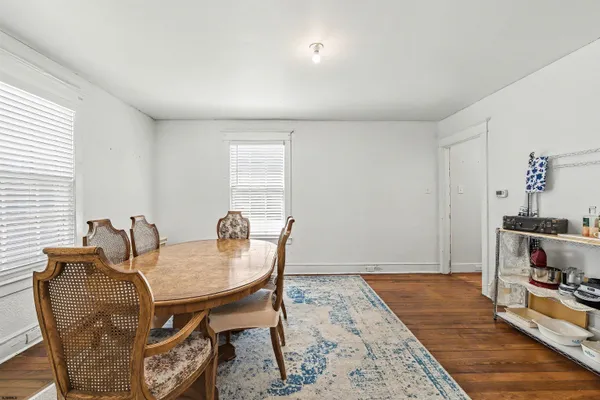 a dining room with furniture and wooden floor