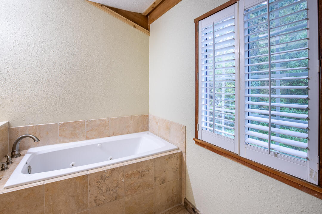 5503 Raintree Trail Fort Pierce, FL 34982 - Photo 23 of 34 a bathroom with a bathtub and a shower
