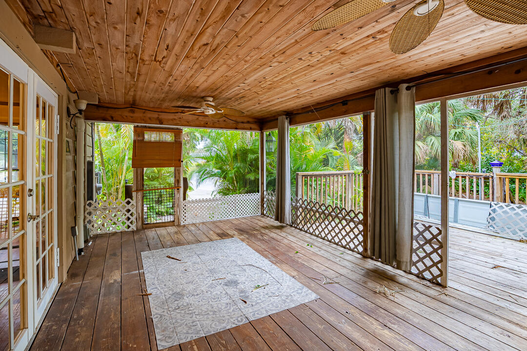 5503 Raintree Trail Fort Pierce, FL 34982 - Photo 26 of 34 a view of backyard with wooden floor and iron stairs