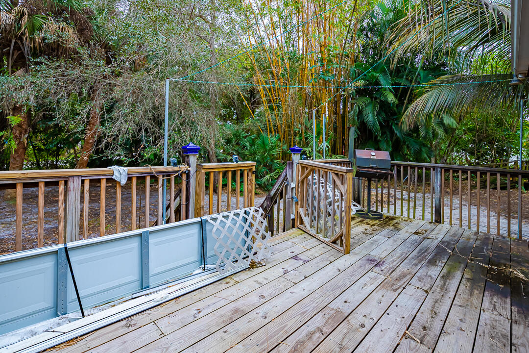 5503 Raintree Trail Fort Pierce, FL 34982 - Photo 27 of 34 a view of balcony with wooden floor and fence