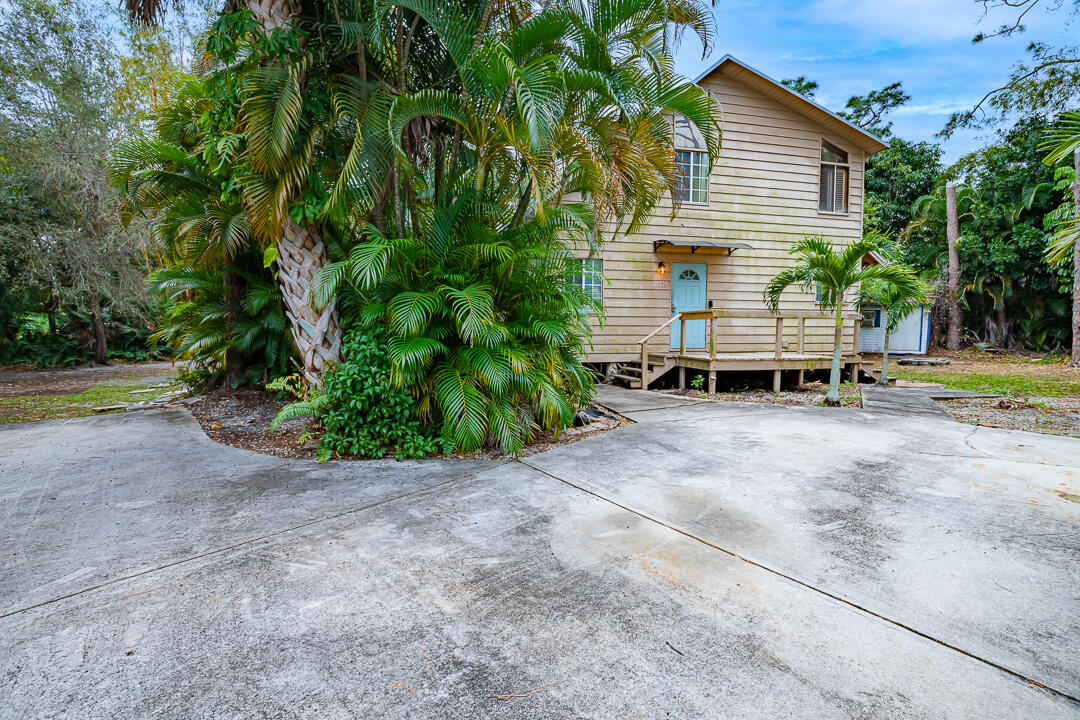 5503 Raintree Trail Fort Pierce, FL 34982 - Photo 30 of 34 a view of backyard with a garden and slide