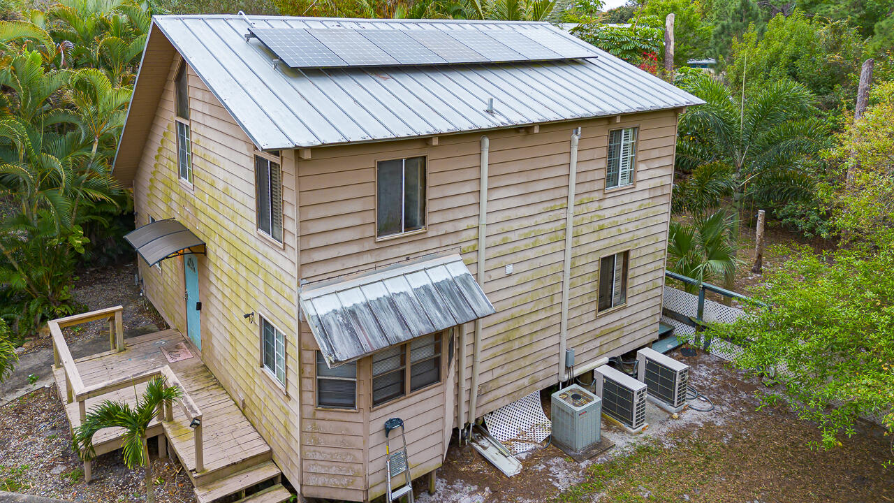 5503 Raintree Trail Fort Pierce, FL 34982 - Photo 33 of 34 a front view of a house with chairs and stairs