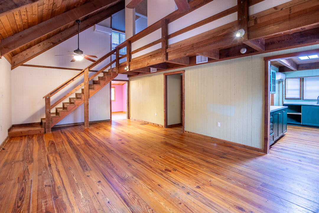 5503 Raintree Trail Fort Pierce, FL 34982 - Photo 9 of 34 a view of an empty room with wooden floor