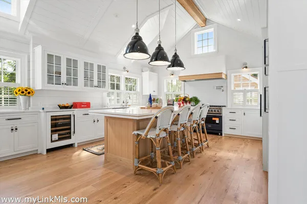 a dining room with furniture a rug and a large window