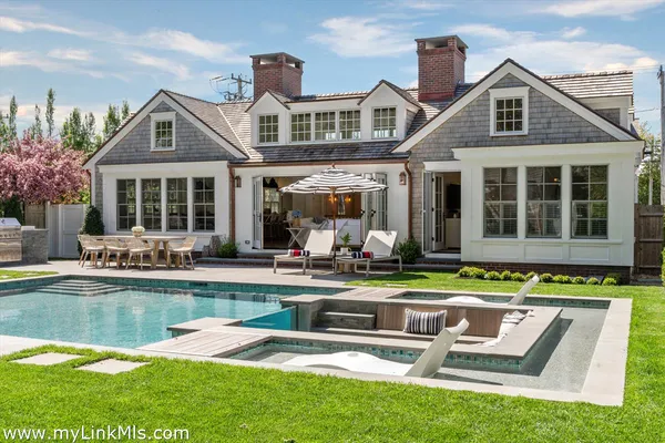 a front view of a house with swimming pool and porch