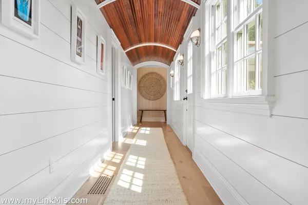 a living room with furniture a rug and a flat screen tv