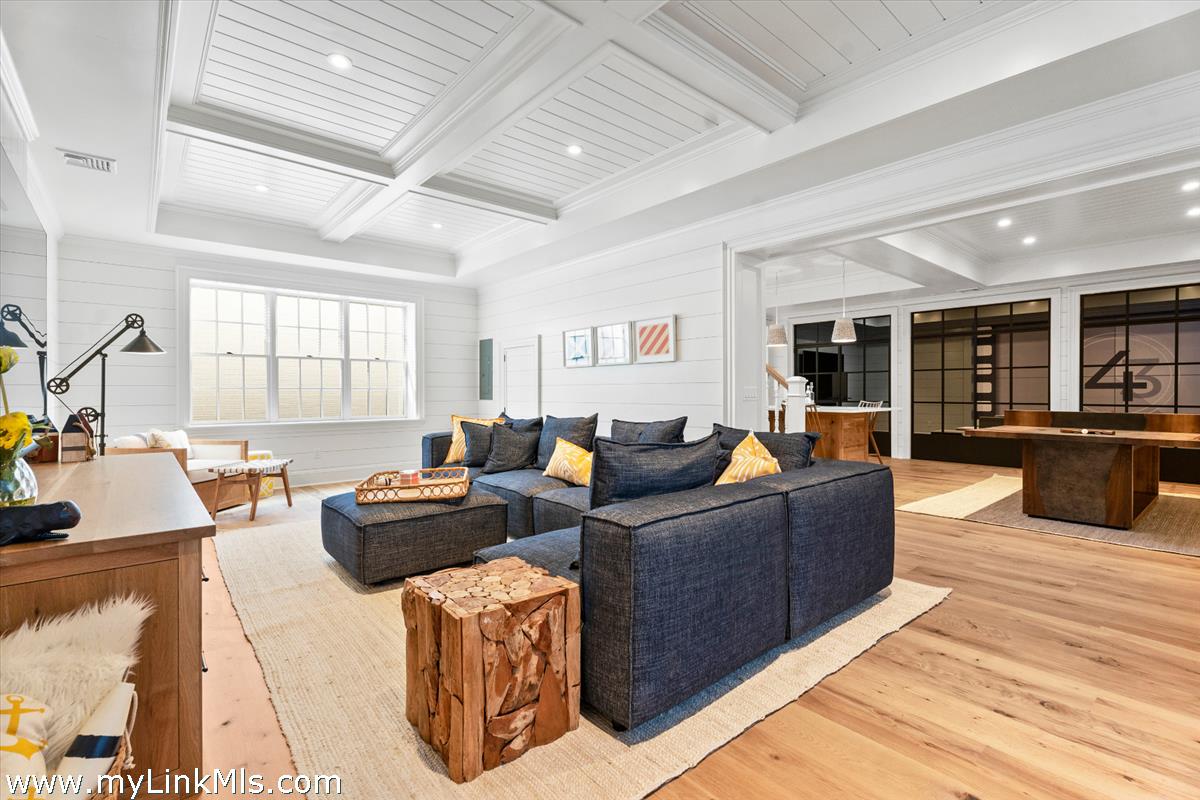 43 Peases Point Way South Edgartown, MA 02539 - Photo 38 of 52 a living room with furniture a large window and wooden floor