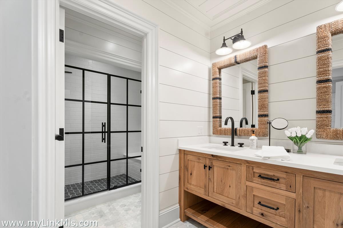 43 Peases Point Way South Edgartown, MA 02539 - Photo 48 of 52 a bathroom with a double vanity sink a mirror and