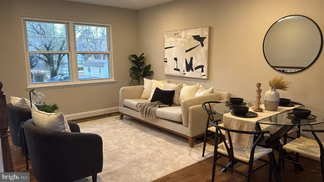 a living room with furniture and a mirror