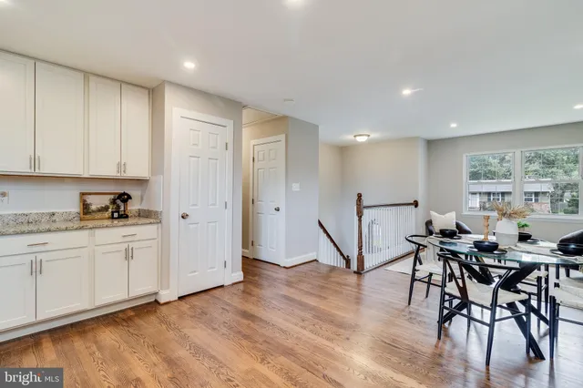 a view of a kitchen with dining area a sink and wooden floor