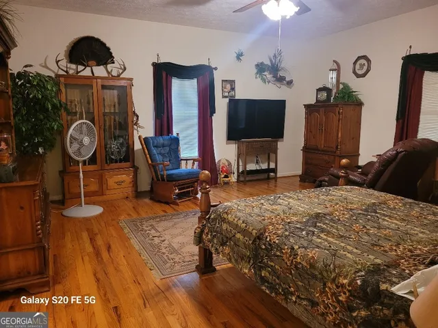 a bedroom with furniture a bed and a flat screen tv