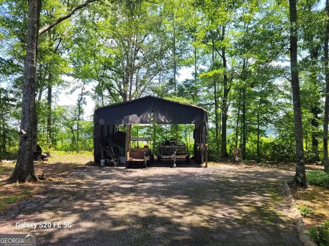 a view of a house with a tree in front of it