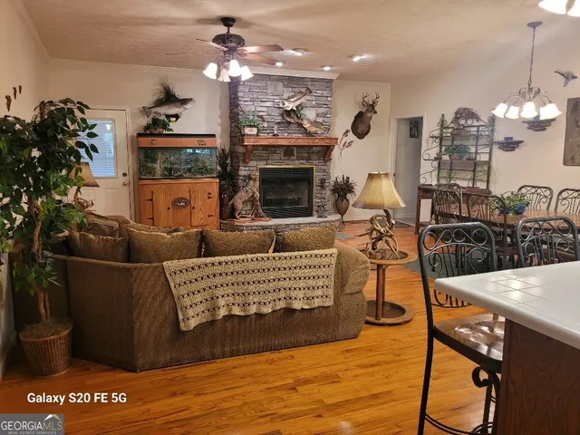 a living room with furniture a chandelier and a fireplace