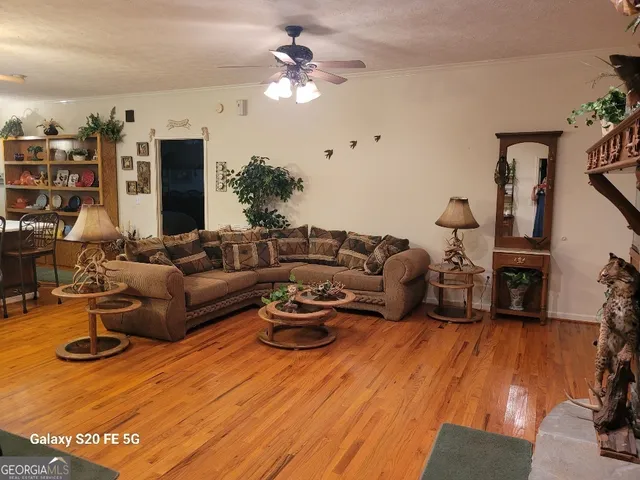 a living room with furniture kitchen view and a fireplace