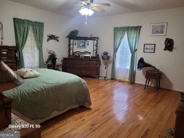 a bedroom with a bed window and a dresser