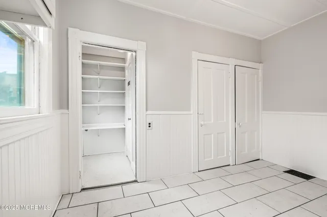 a view of an empty room and closet area