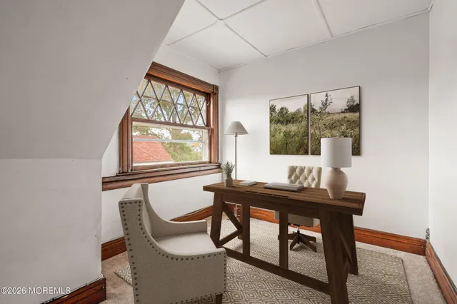 a dining room with furniture and window