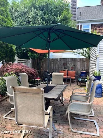 a backyard of a house with barbeque oven table and chairs