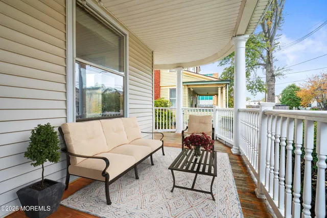 a balcony with furniture and wooden floor