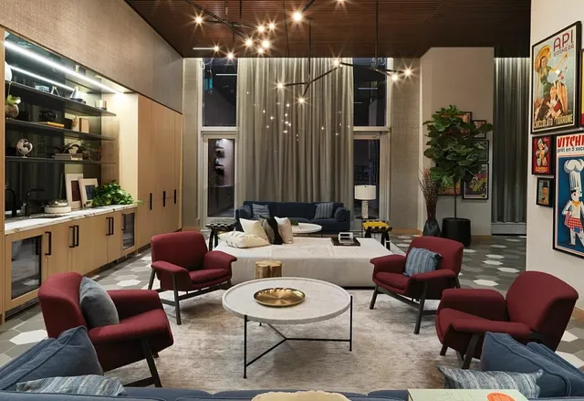 a living room with furniture and large windows