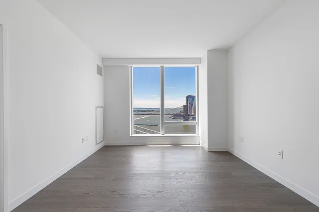 a bedroom with a large bed and a large window
