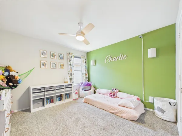a bedroom with furniture and a large window