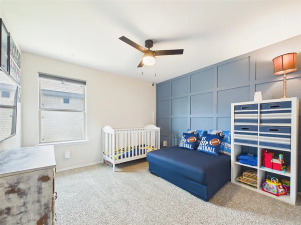 a bedroom with furniture and a book shelf