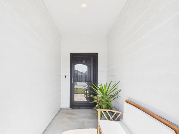 a view of a hallway with a potted plant