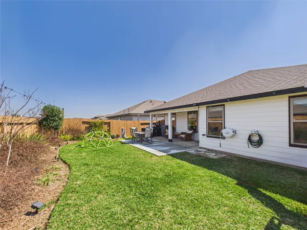 a front view of a house with patio and garden