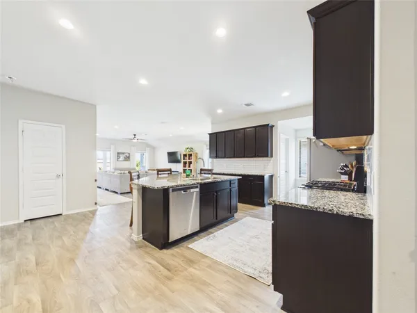 a large kitchen with a large counter top appliances and cabinets