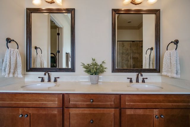 a spacious bathroom with double vanity and a mirror
