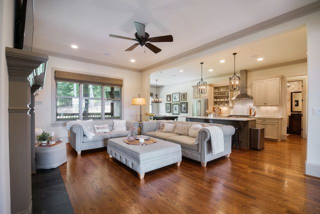 a living room with stainless steel appliances furniture and a view of kitchen
