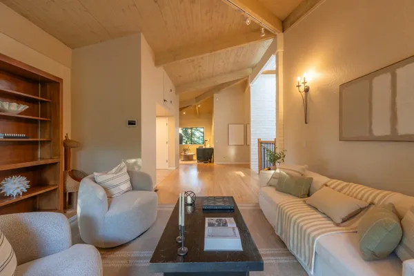 a living room with furniture and a book shelf