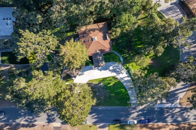an aerial view of a house with a yard swimming pool and outdoor seating