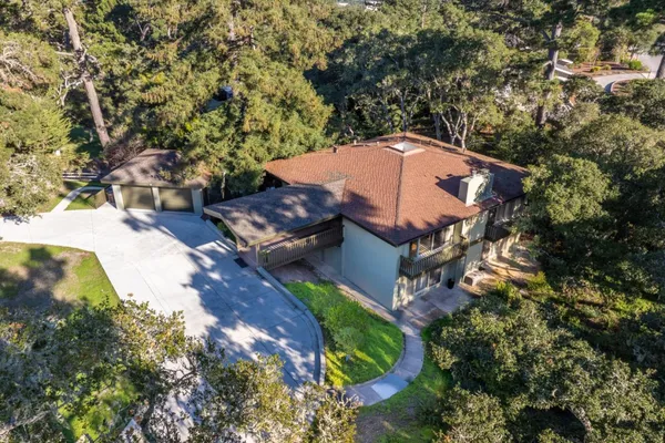an aerial view of a house with a yard
