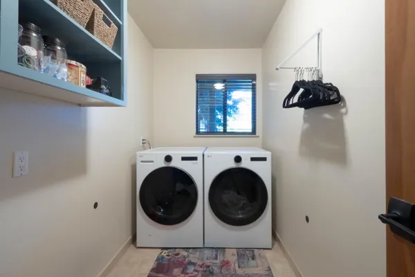a bedroom with a large bed cabinets and a walk in closet