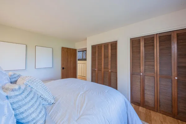 a spacious bedroom with a bed and a window