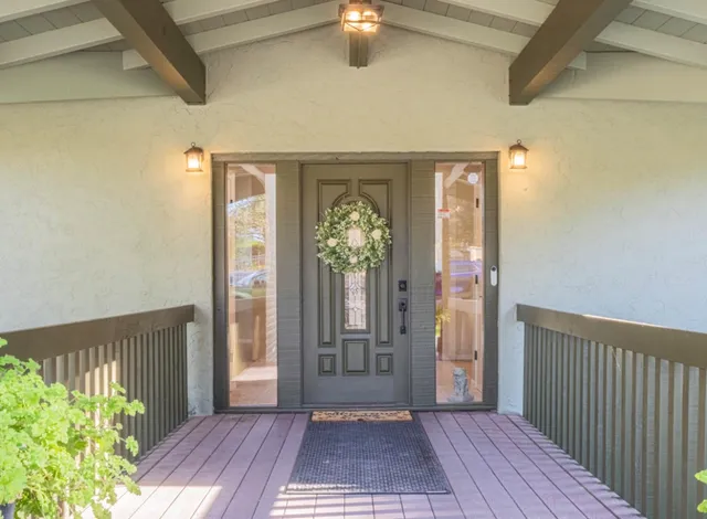 a view of a hallway with wooden floor and a chandelier